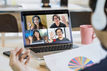 Rear View of Asian Business man say hello with teamwork colleague in video conference