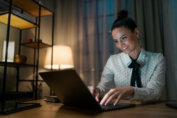 Mid adult business woman working on laptop