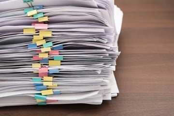 A stack of papers, good documentation for remote team management concept