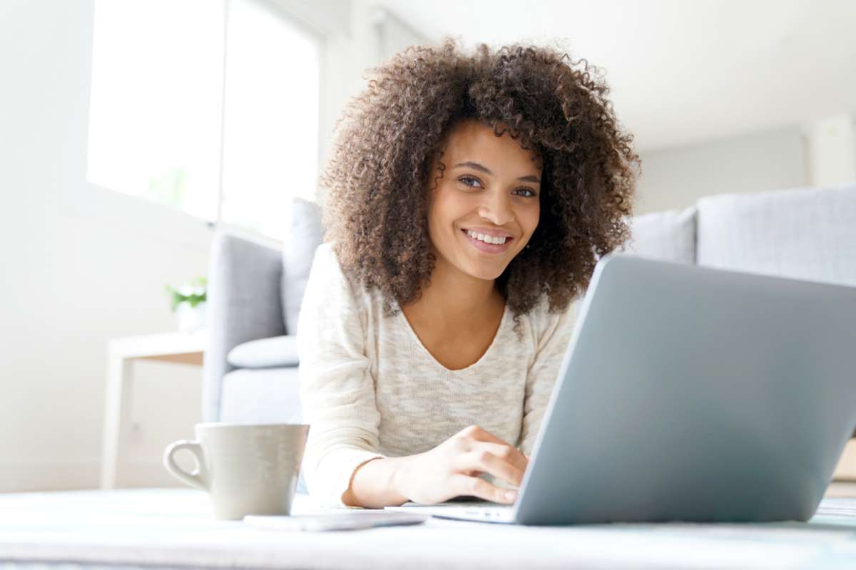 A young woman working at a computer, a VA found through virtual property management companies concept