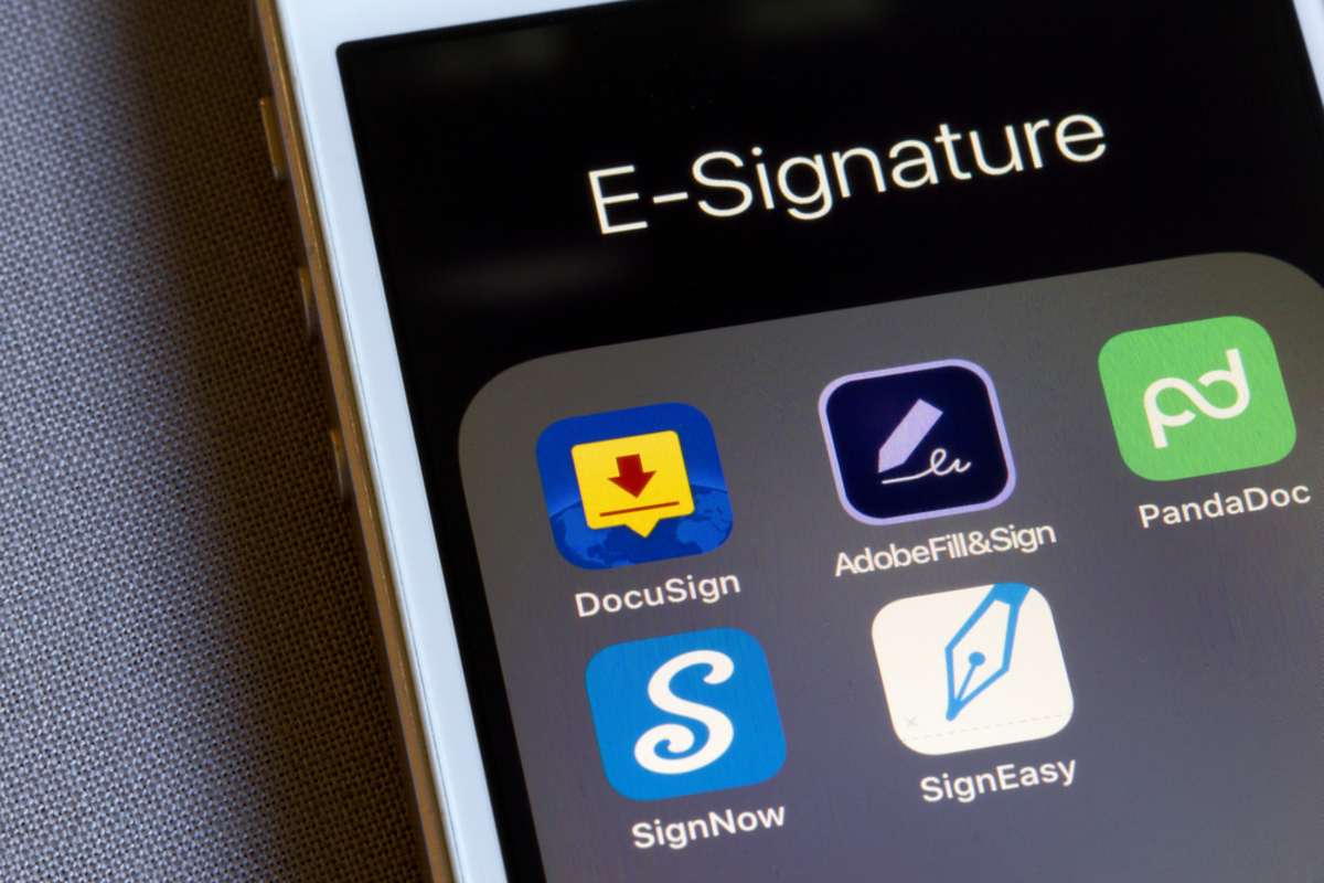 Assorted e-signature app icons are seen on an iPhone-1