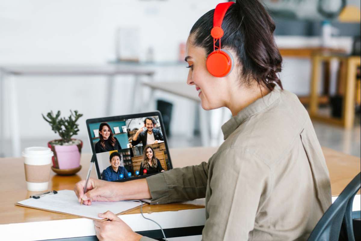 Back view of business latin woman talking to her mexican colleagues in video conference