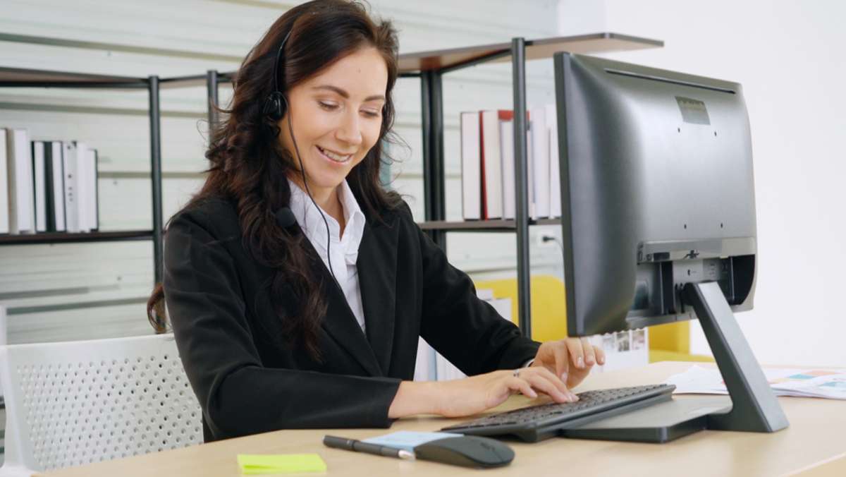 Business people wearing headset working in office to support remote customer or colleague