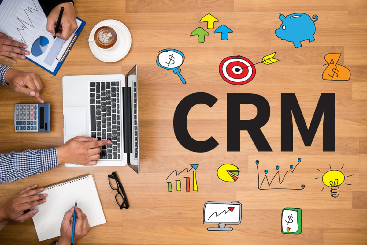 CRM next to different icons and a laptop