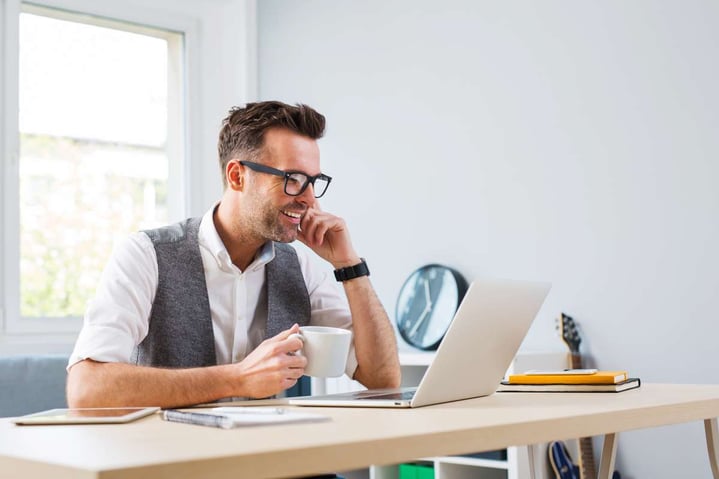 Happy man working on laptop