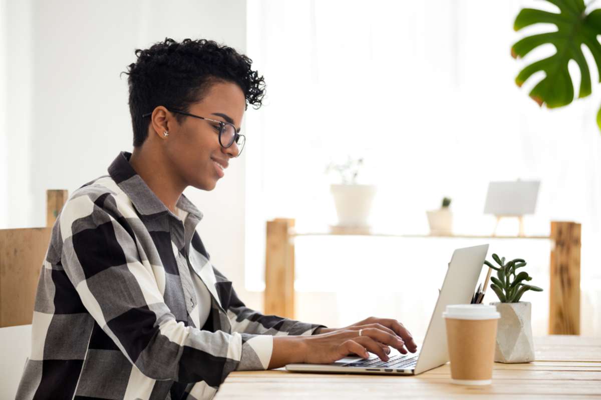 Happy woman working at a computer, marketing virtual assistant concept