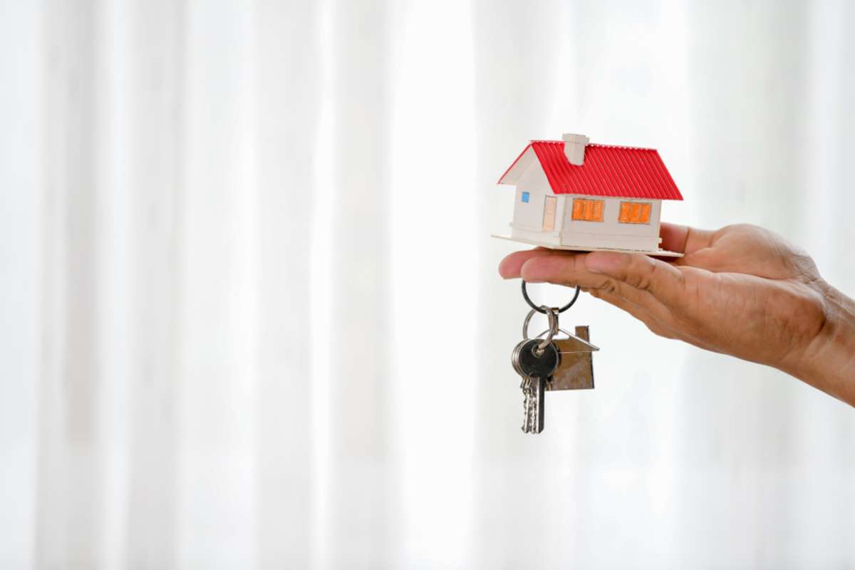 House keys on the rental agreement or the buy home contracts with the real estate property background