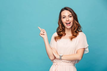 Image of happy young lady standing isolated over blue background