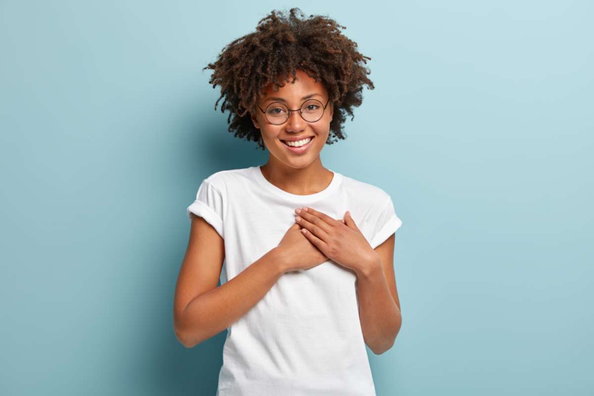 A happy woman shows that it's possible to find trustworthy remote team members. 