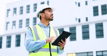Man in a hard hat conducting commercial property maintenance services