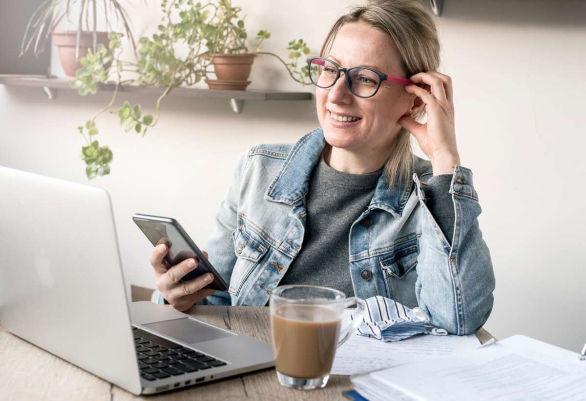 Nice business woman in a cozy workplace works with pleasure