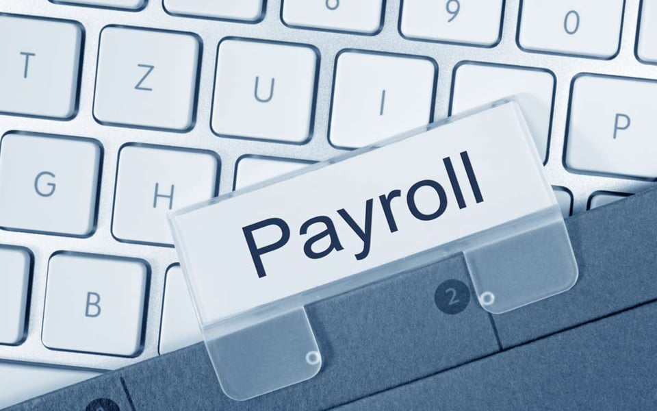 Payroll key on a keyboard indicates "how much do you pay a virtual assistant?"