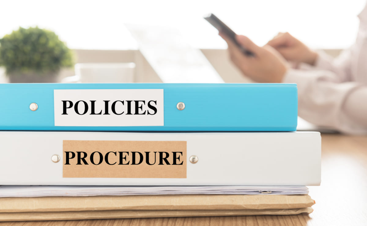 Policies and Procedure on binders, good documentation for managing virtual team members concept