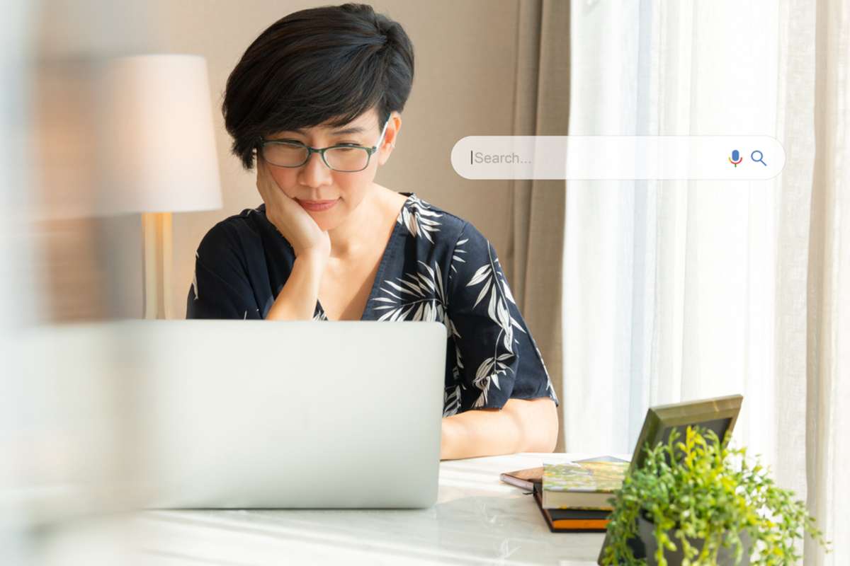 Portrait of a beautiful middle-aged asian woman using laptop computer a on the table