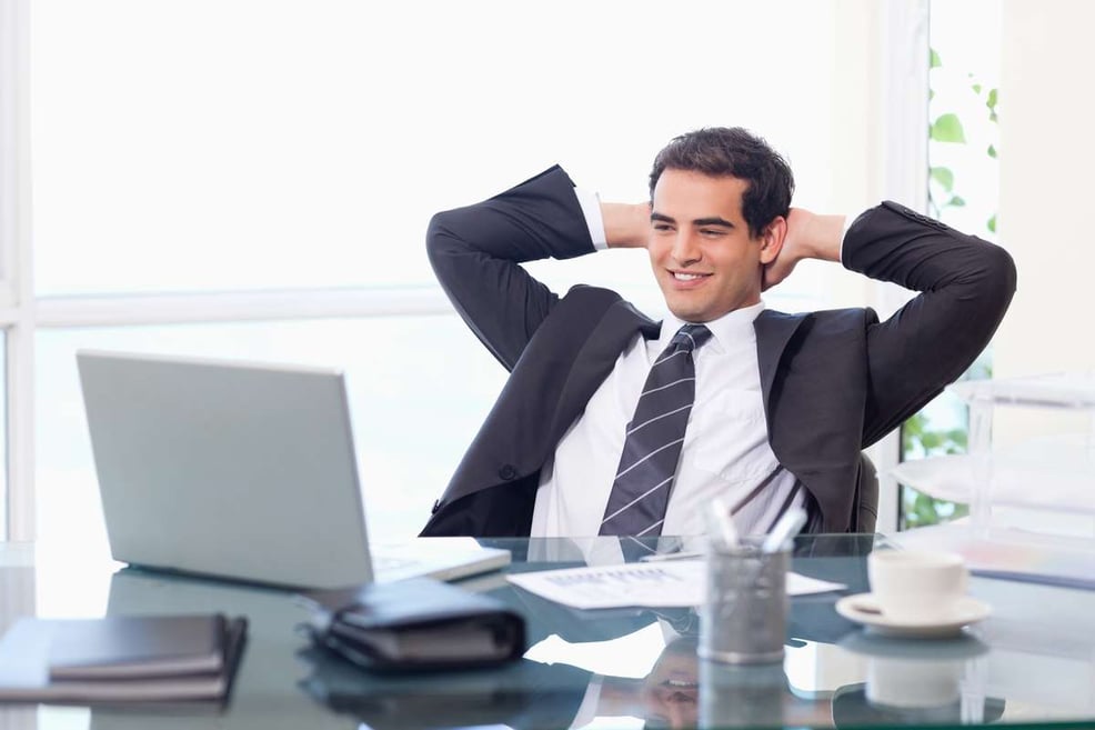 Relaxed businessman working with a laptop, property management virtual assistant concept. 