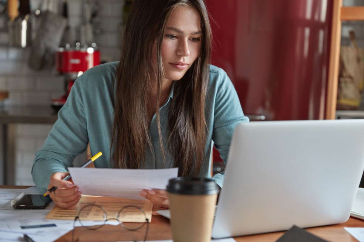 Serious trading manager has focused expression into laptop screen