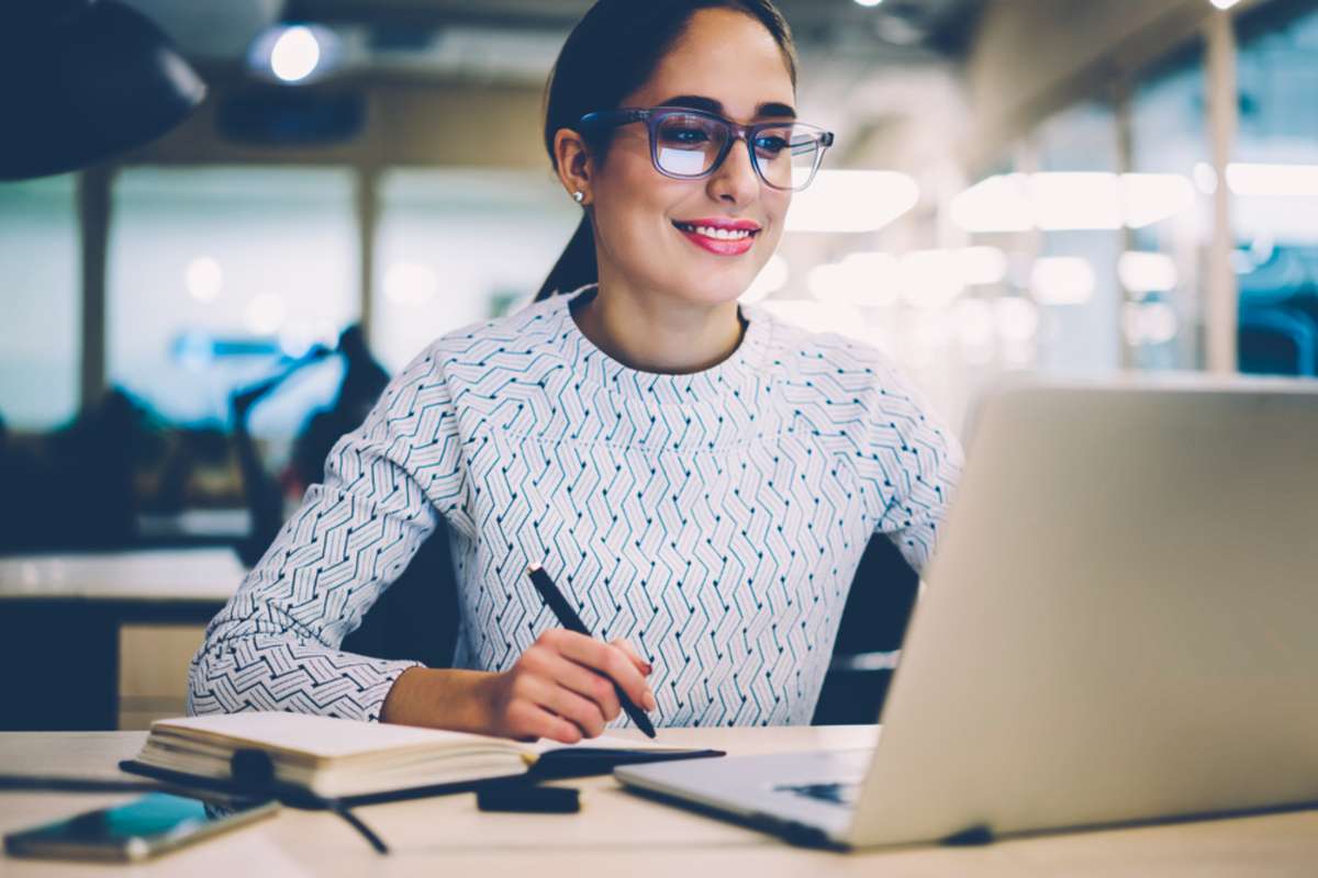 Smart young woman satisfied with learning language during online courses using netbook