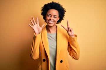 Smiling woman holding up seven fingers, digital marketing virtual assistant concept