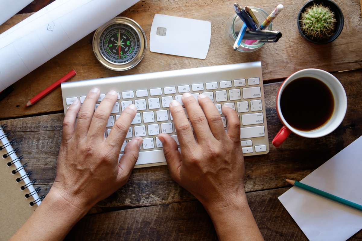 View from above of Man typing with credit card and using PC for online shopping