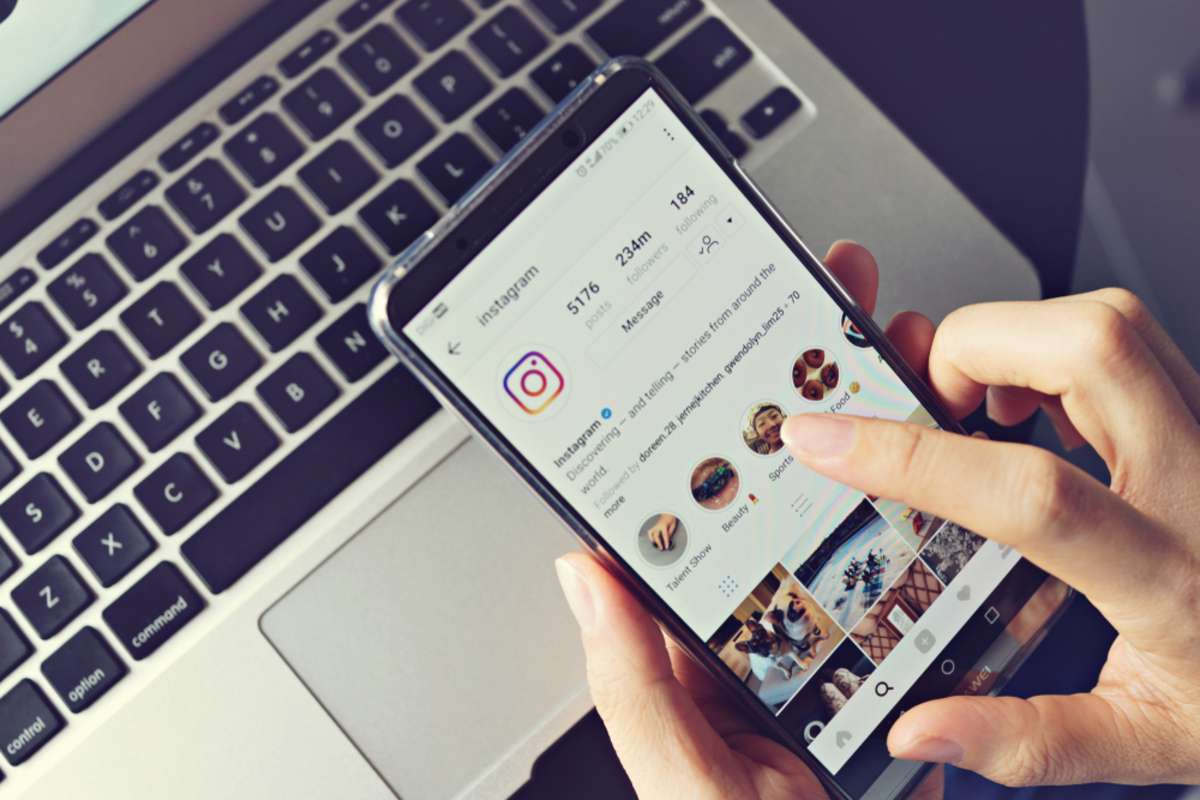 Woman holding smartphone with social internet service Instagram on the screen
