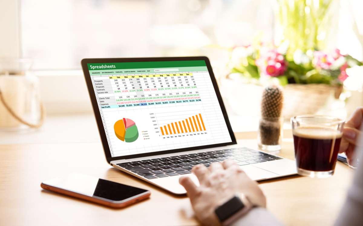 Woman working with spreadsheets on laptop computer