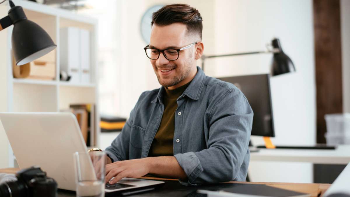 Young businessman working with laptop at office