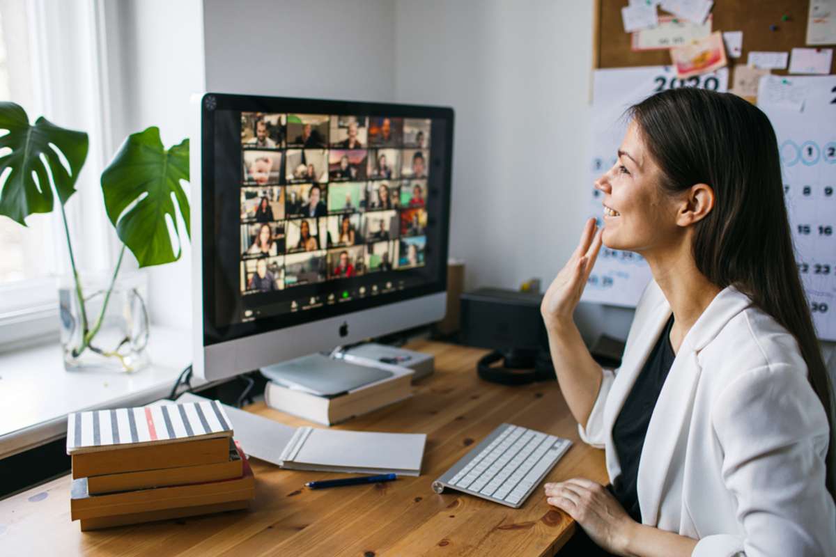 Young woman having video Zoom call via computer in the home office