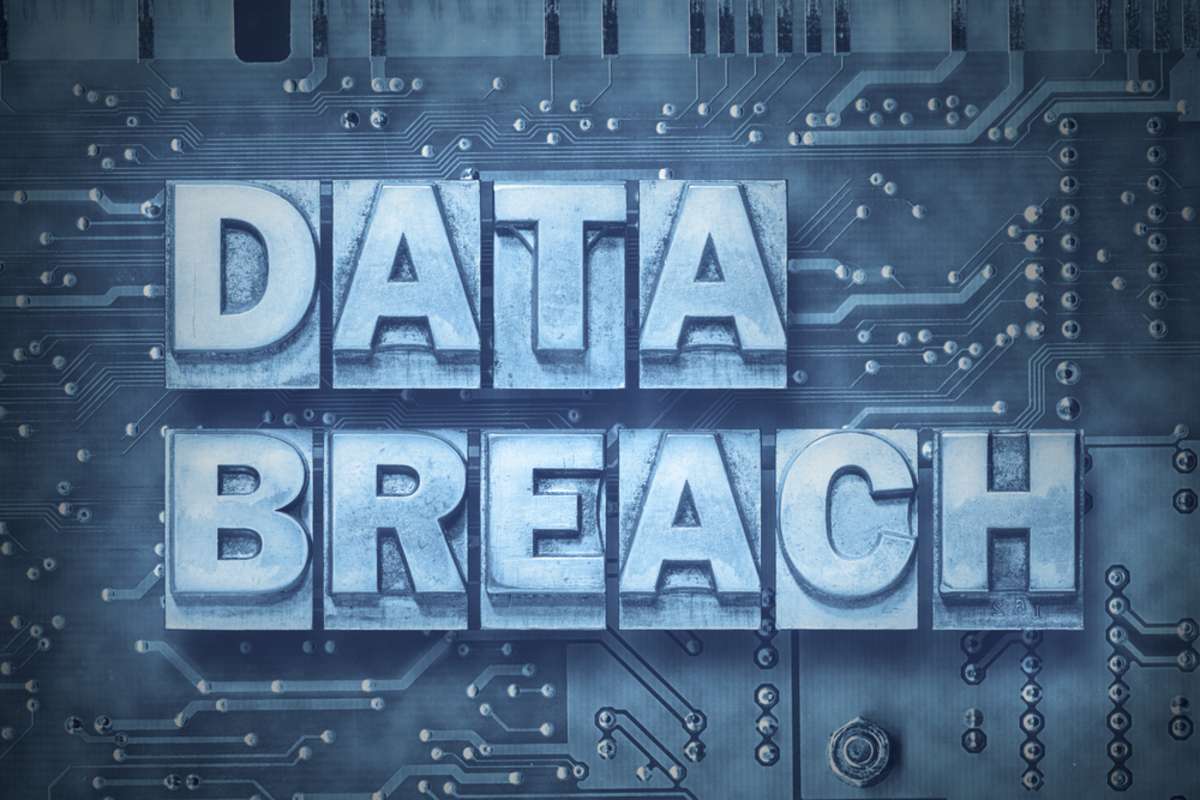 data breach made from metallic letterpress blocks on the pc board background