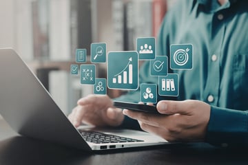 Property manager working at a laptop while AI tools assist in the background.