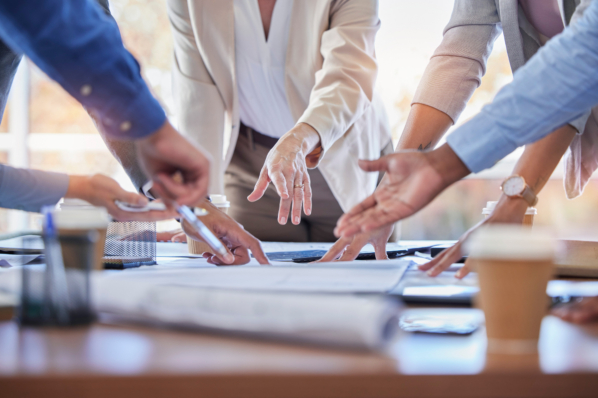 Business people, hands and meeting with documents in strategy, planning or ideas together at office