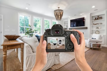 Photographer Holding Camera Displaying Rental Home Showing