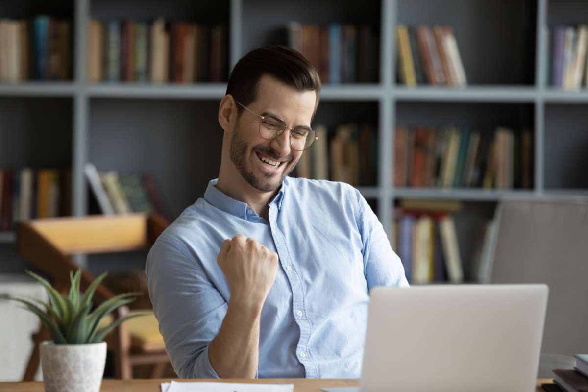 Excited man wearing glasses celebrating success