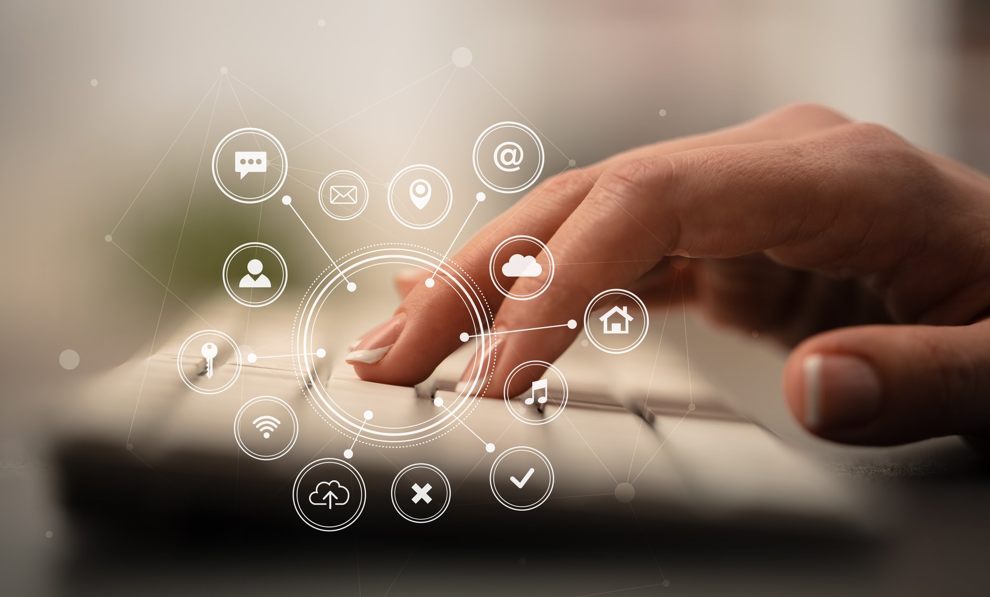 Close-up of a hand typing on keyboard with application icons, virtual property management assistant concept. 