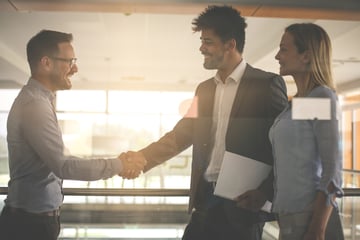 Multiracial business professionals shaking hands