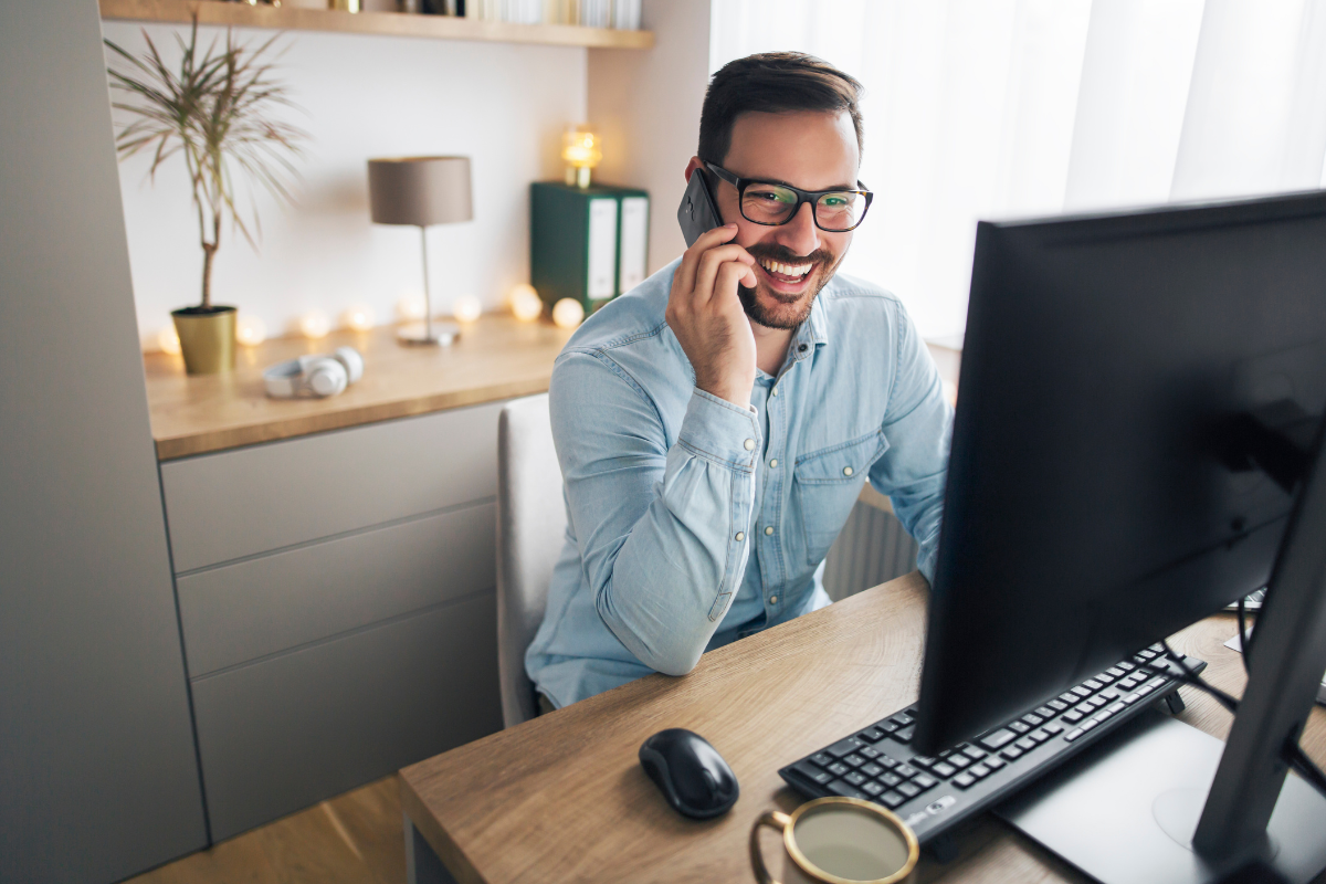 Remote Worker Using Computer At Home Office Desk