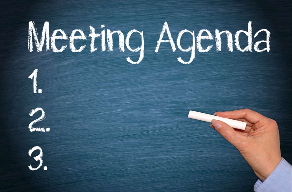 meeting agenda written on chalkboard