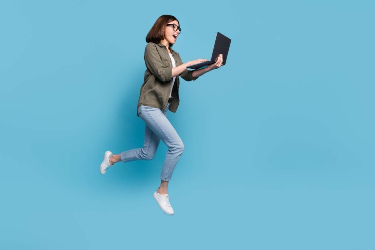 A happy woman with a laptop, what is virtual assistance concept