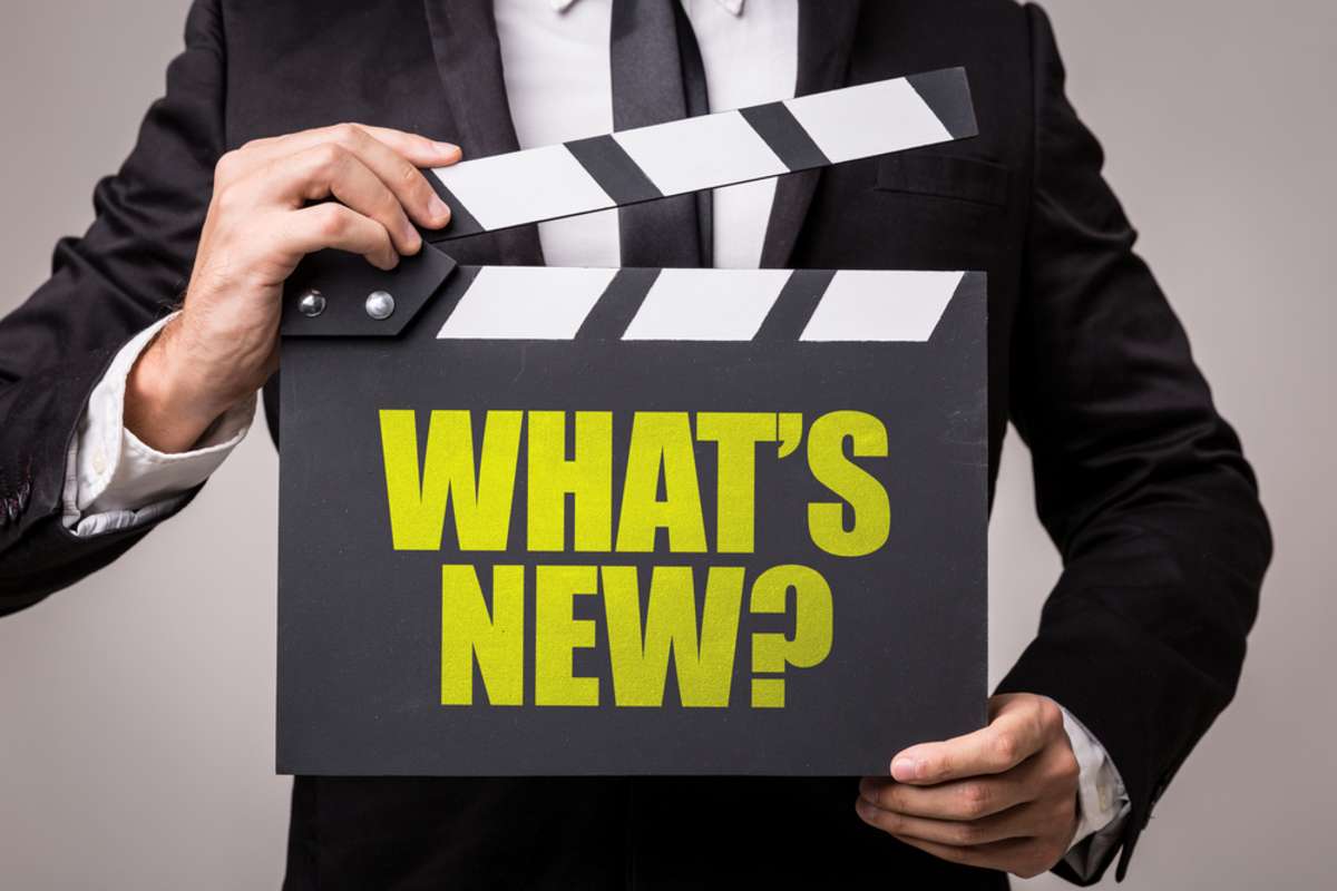 What's New on a movie clapboard, new platform features to find remote team members concept